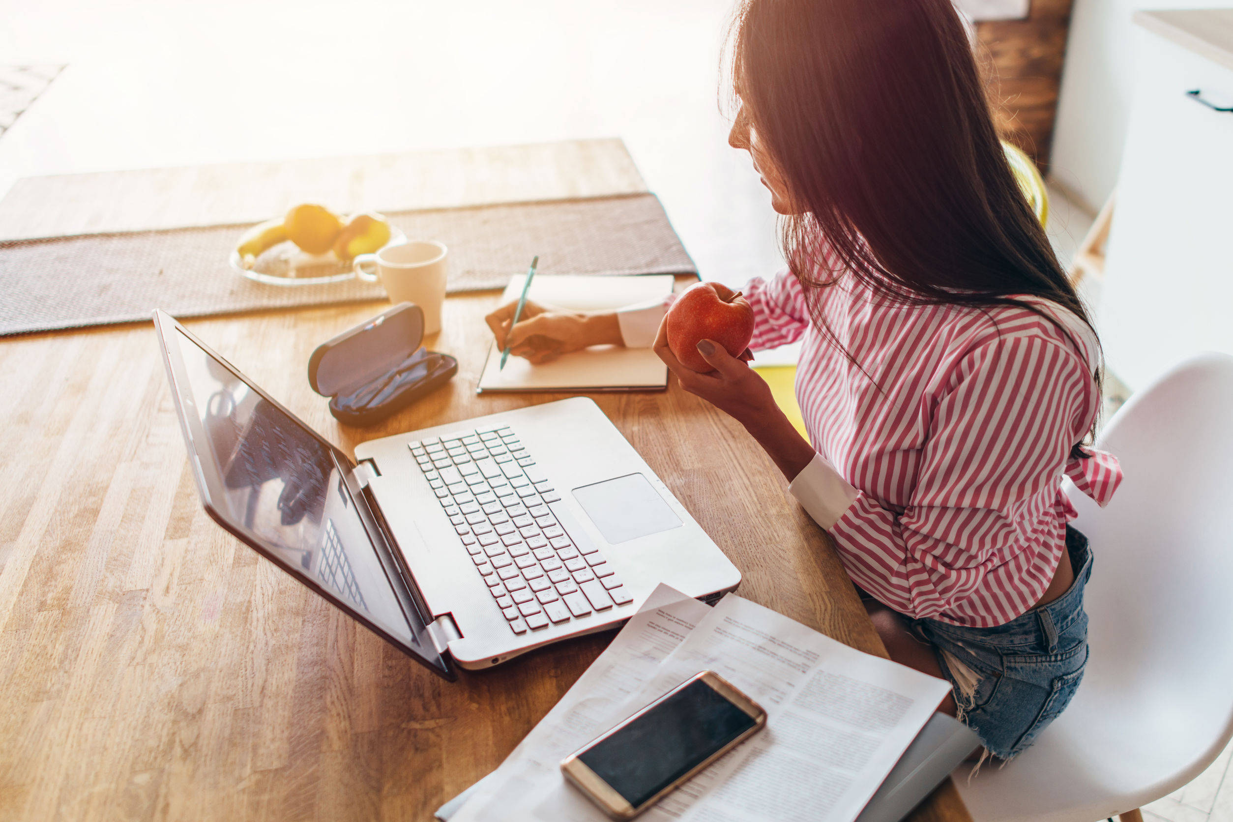 Young woman at home working on laptop.