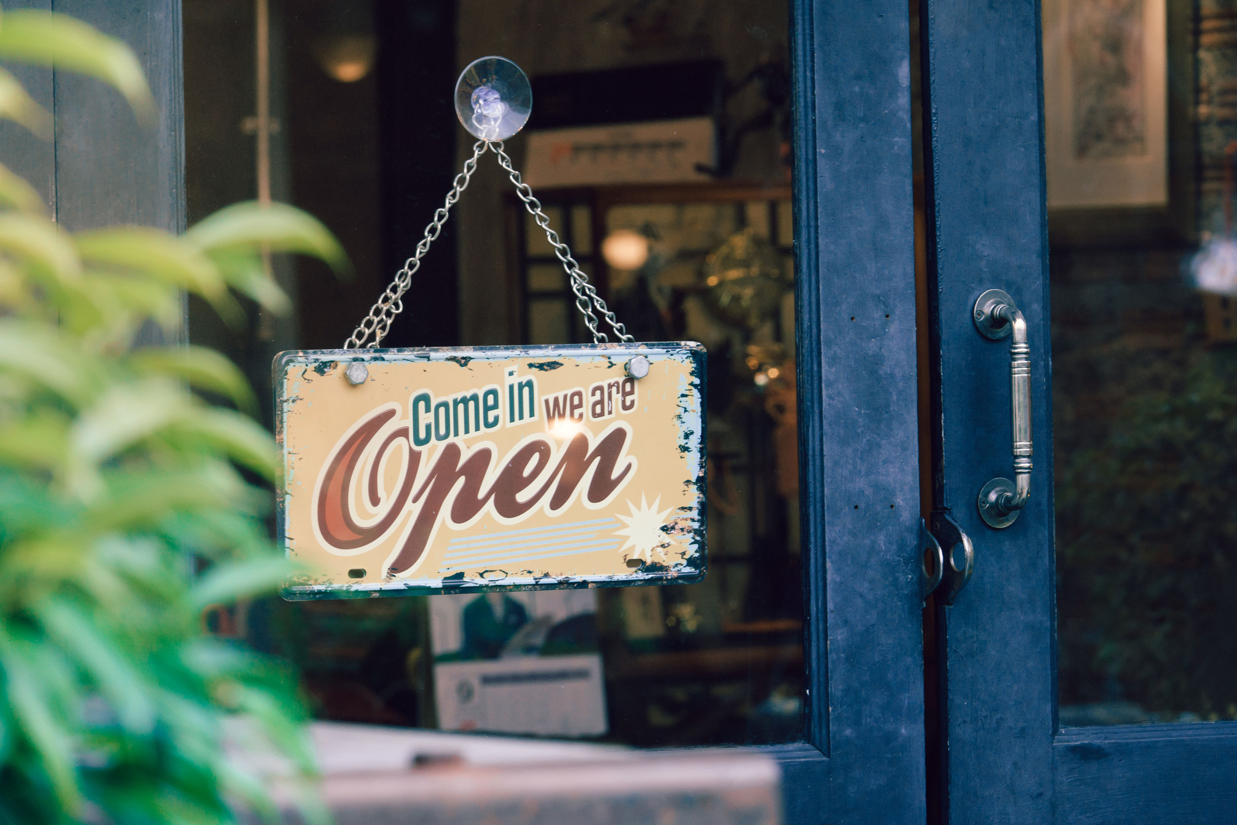 Open sign hanging on shop door