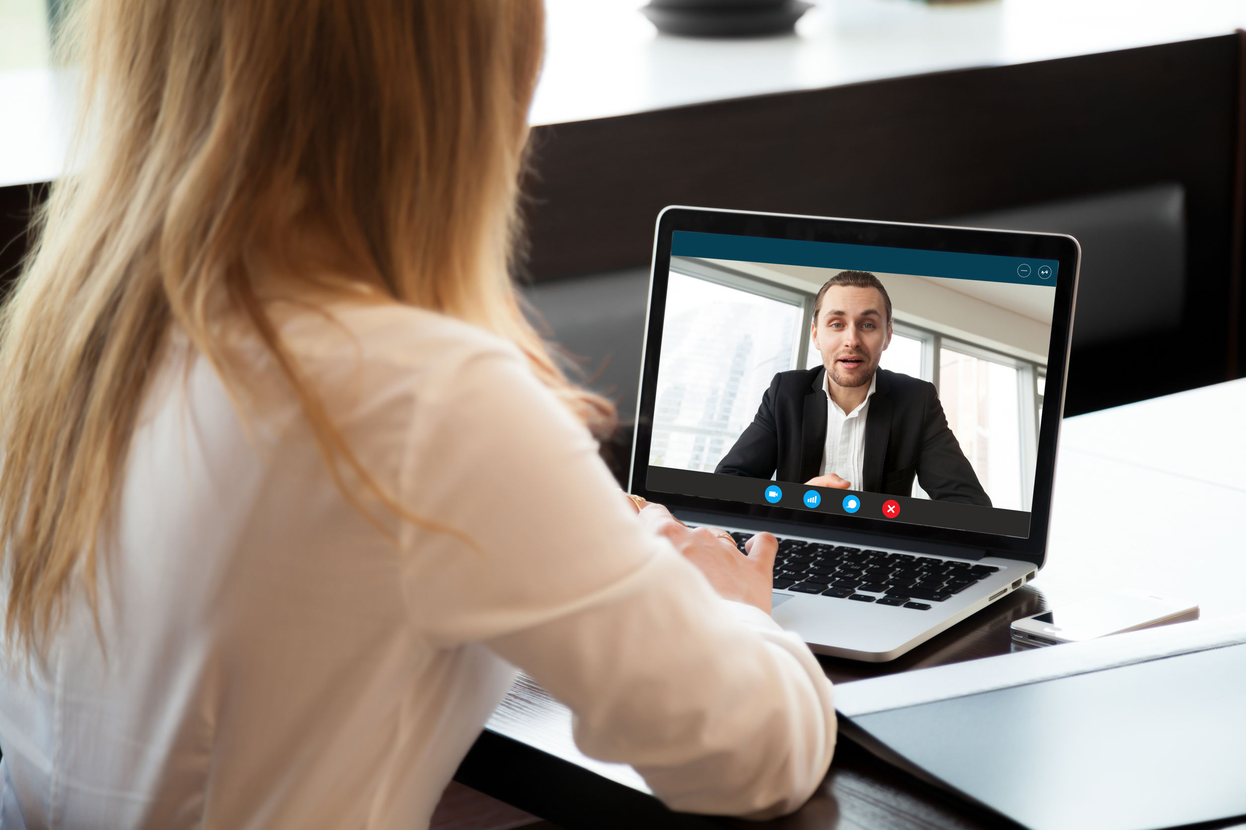 Woman at desk in virtual meeting