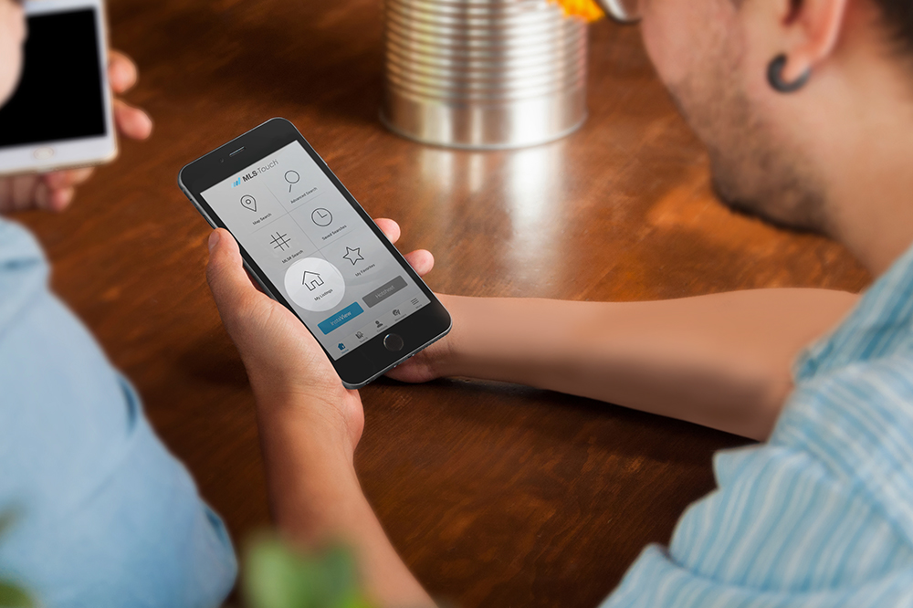Image description: Heartland MLS subscriber uses MLS-Touch on their smartphone.