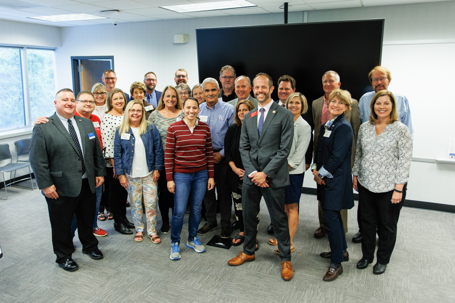 Image description: A group of REALTORS® pose with Congresswoman Sharice Davids after their meeting.