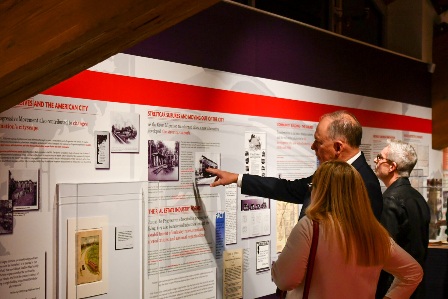 Image description: Jeff Carson and another KCRAR member view the Redlined exhibit at last year's reception event.