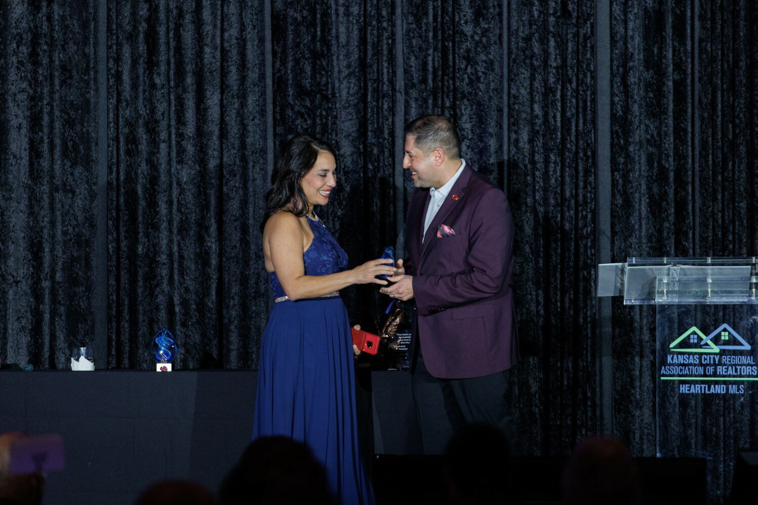Image description: 2022 Salesperson of the Year accepting her award on stage at the Holiday Party.