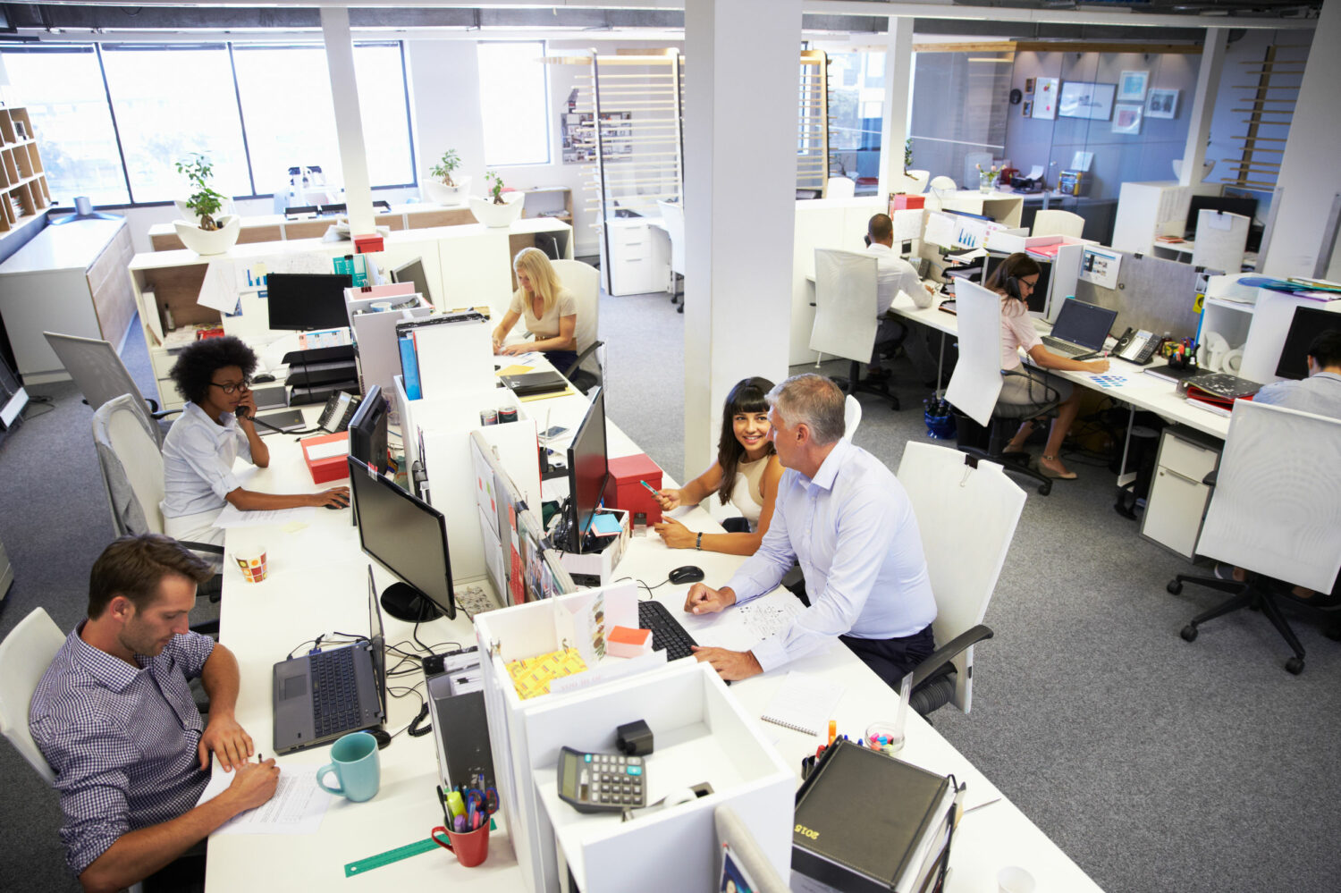 Image description: people working in a busy office