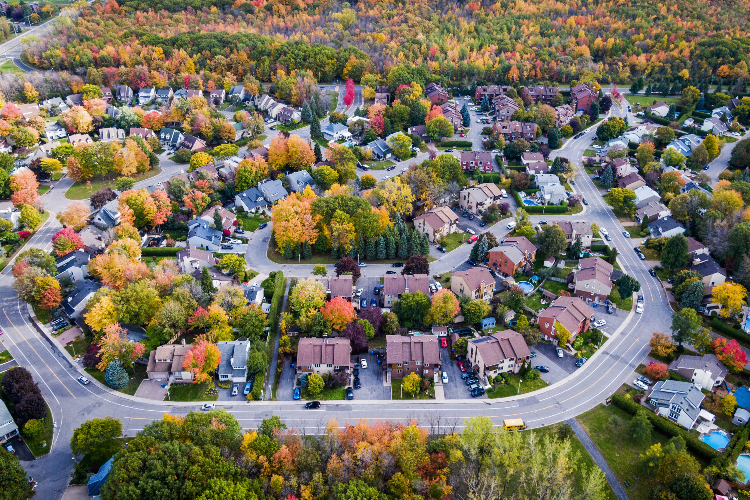 Image description: Residential neighbourhood in the suburbs during autumn season, aerial view.